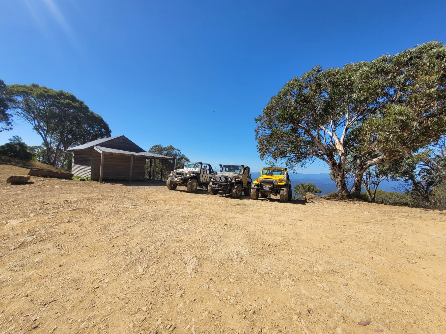 Classic LandCruisers at a scenic mountain lookout